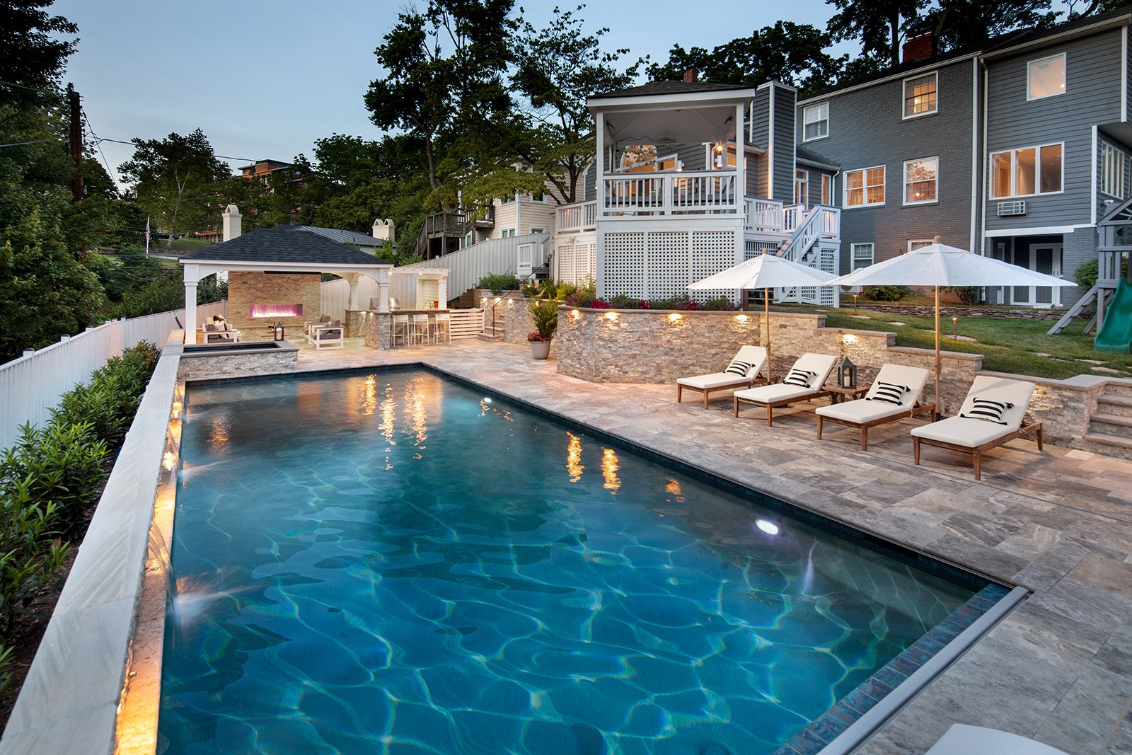 Luxury pool and spa area with pavilion complete with fire feature and outdoor kitchen.